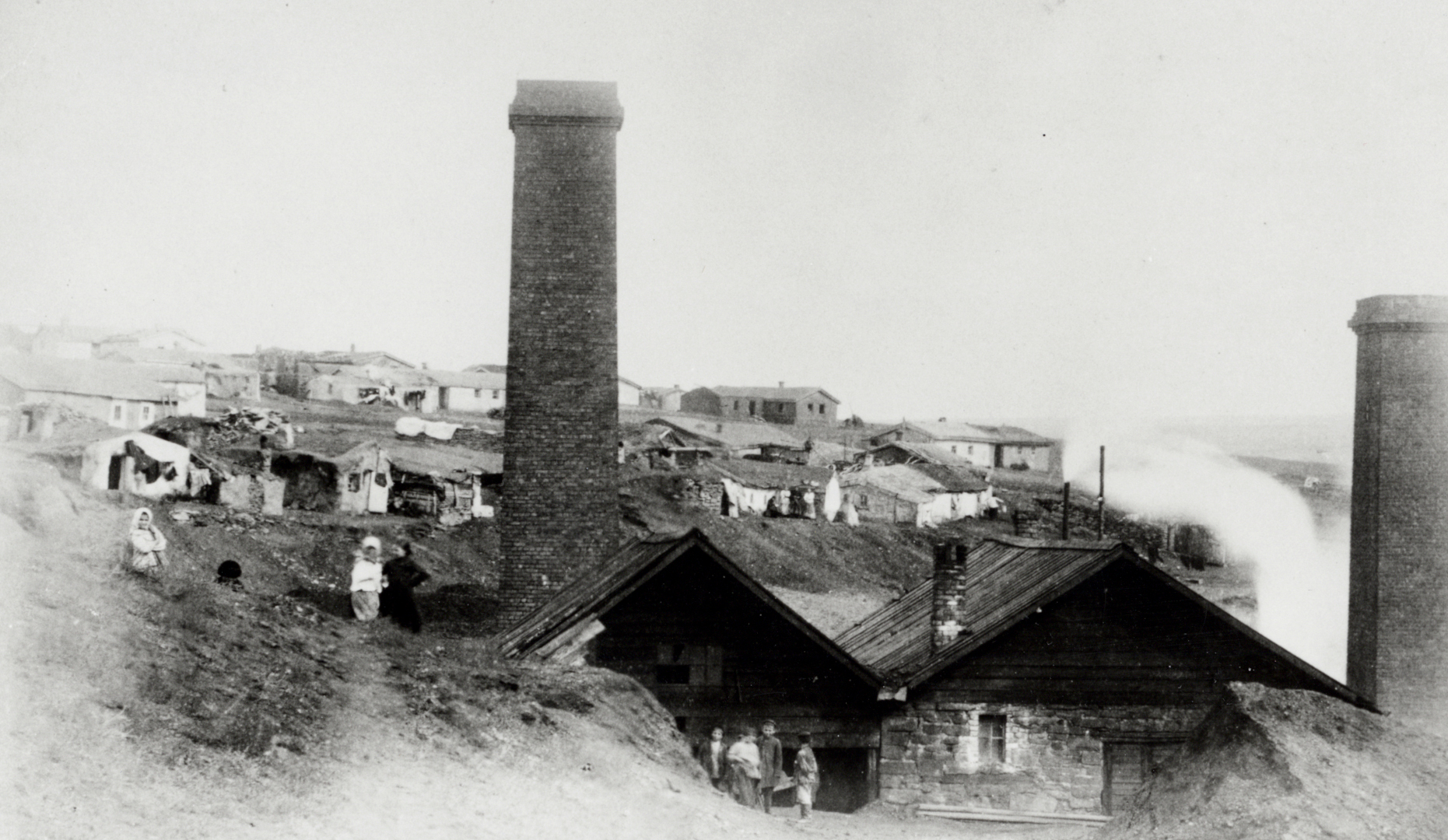 DNMW44/58 Hughesovka, street in commercial area, showing shop signs and articles for sale, dome of church far end of street