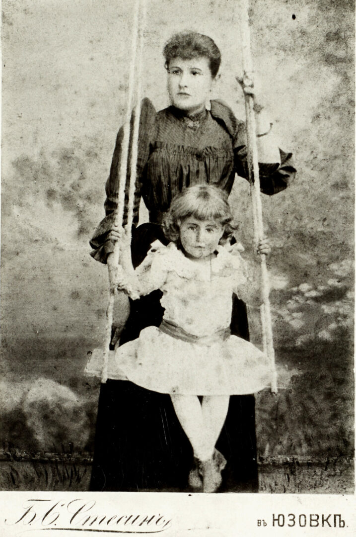 DX700/12 Maria Penkova/Clark with daughter Helen Clark on photographer's swing, Hughesovska, c1916
